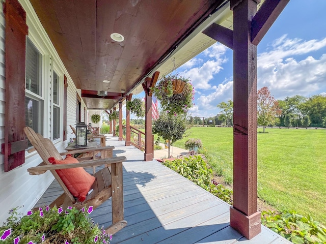 deck featuring a porch and a lawn