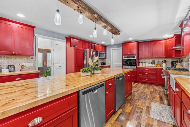 kitchen featuring decorative light fixtures, beam ceiling, wood counters, dark hardwood / wood-style flooring, and appliances with stainless steel finishes