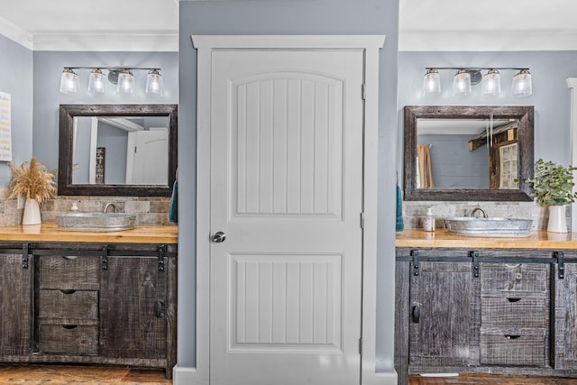 bathroom with vanity and ornamental molding