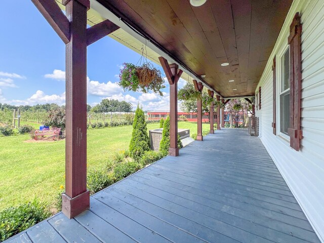 deck with a lawn and a porch