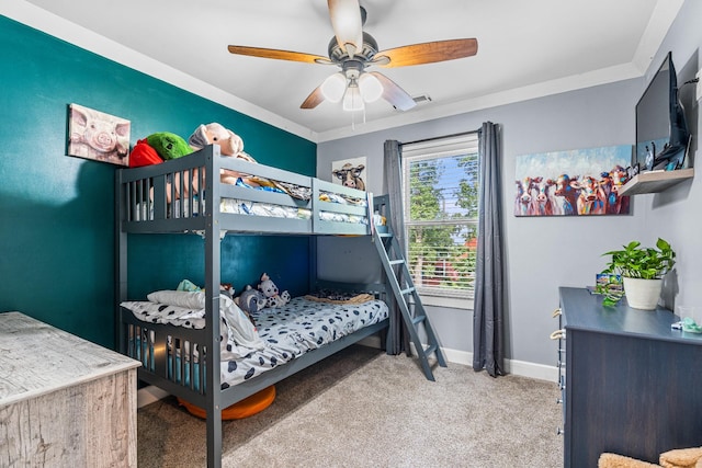 bedroom with carpet floors, ceiling fan, and crown molding