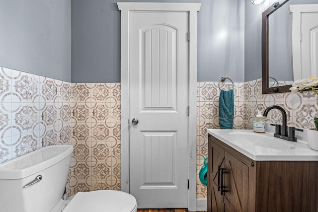 bathroom featuring toilet and vanity