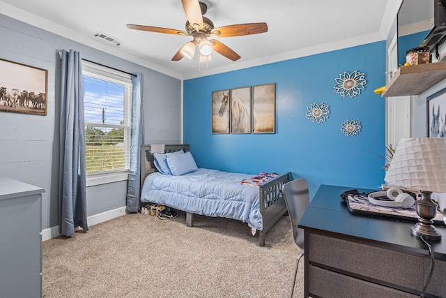 carpeted bedroom with ceiling fan and crown molding