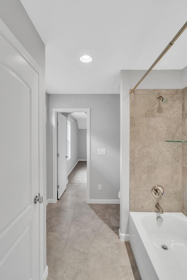 bathroom featuring tile patterned flooring and tiled shower / bath