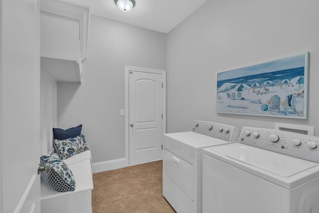 laundry room with light tile patterned floors and washing machine and clothes dryer