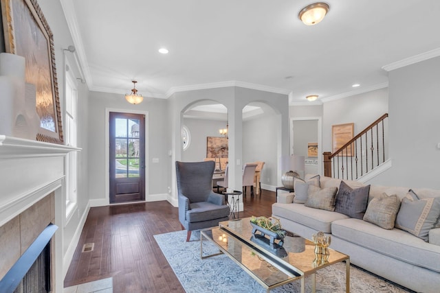 living room featuring a fireplace, ornamental molding, and dark wood-type flooring