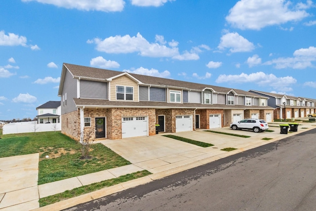 multi unit property with a front lawn and a garage