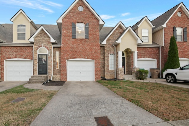 front facade with a front yard and a garage