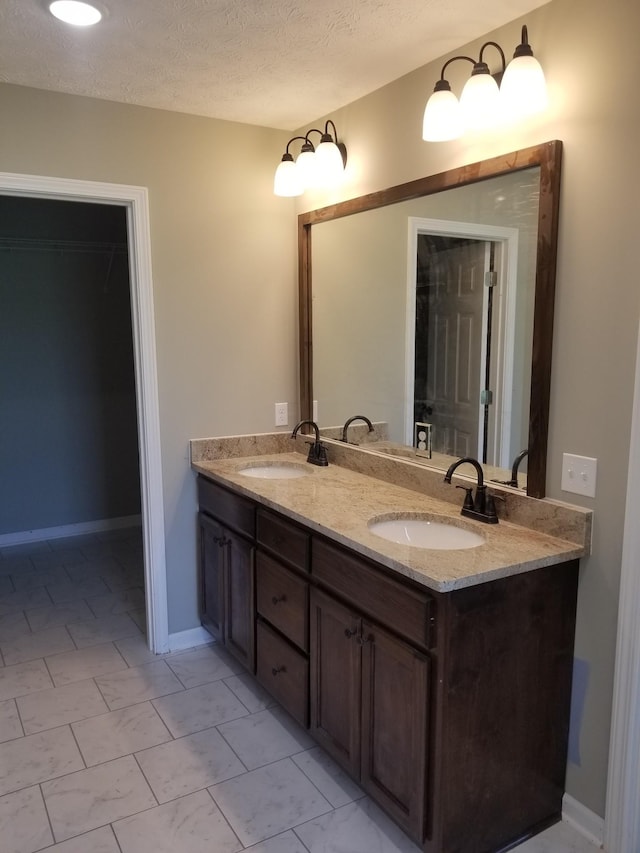bathroom featuring vanity and a textured ceiling