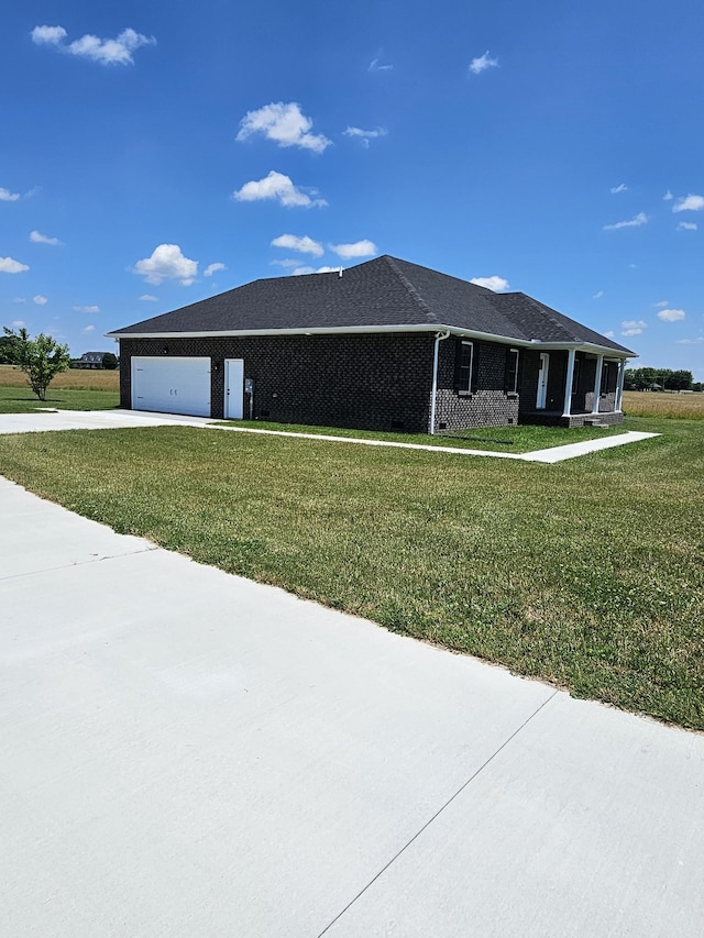view of home's exterior with a lawn and a garage