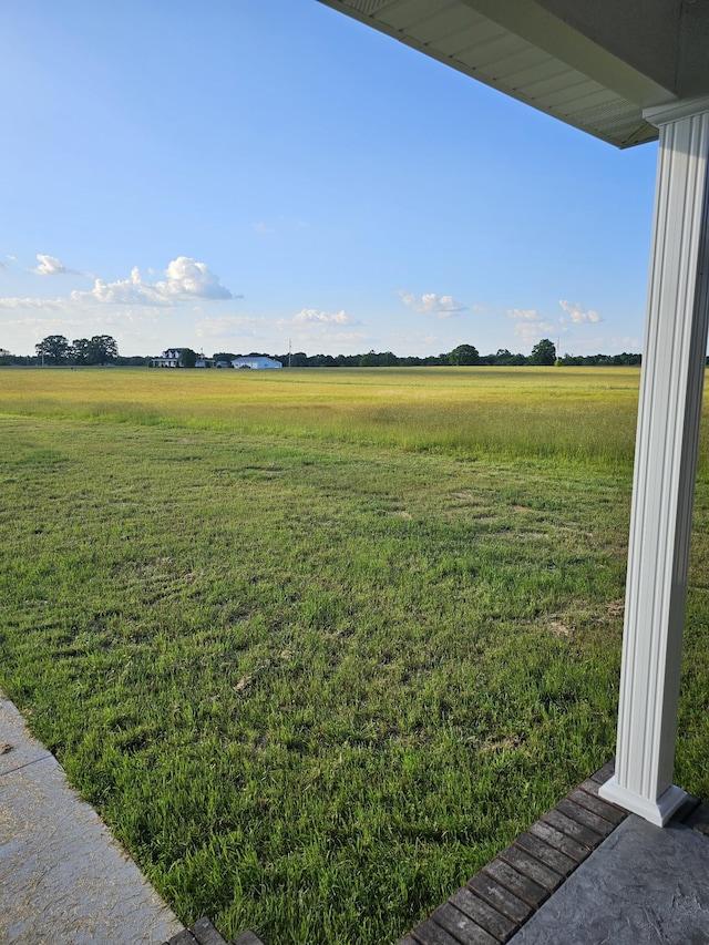 view of yard with a rural view