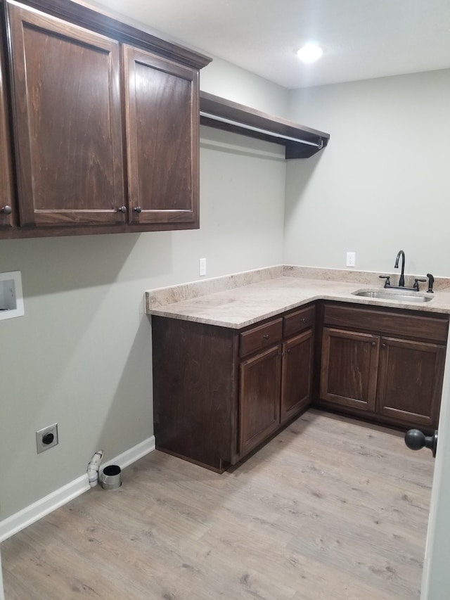 laundry room featuring cabinets, washer hookup, light wood-type flooring, hookup for an electric dryer, and sink