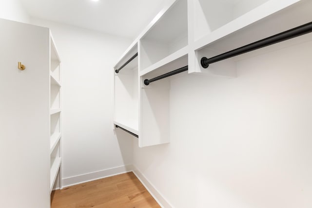 spacious closet with light hardwood / wood-style flooring