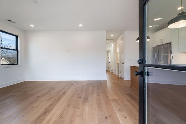 unfurnished room with light hardwood / wood-style flooring