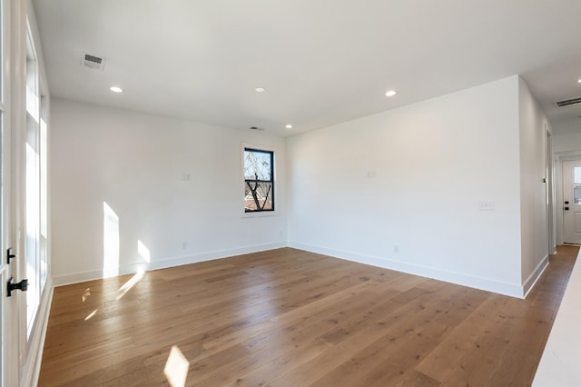 spare room with hardwood / wood-style floors