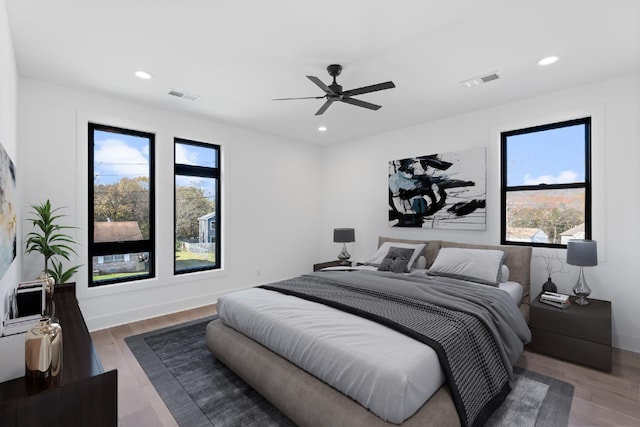 bedroom with ceiling fan and wood-type flooring