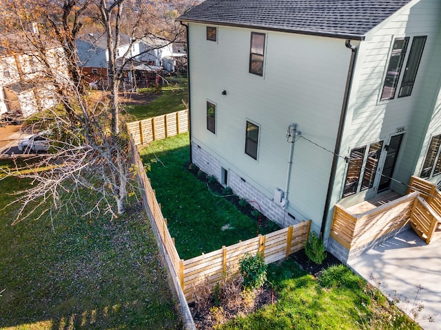 view of side of home featuring a yard