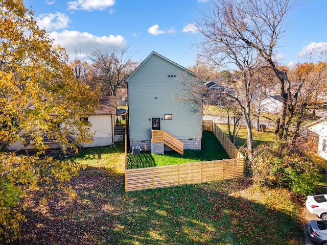 view of side of home with a yard