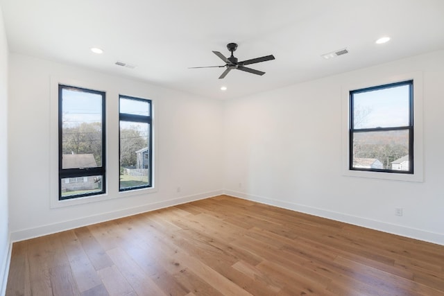 unfurnished room with ceiling fan and wood-type flooring