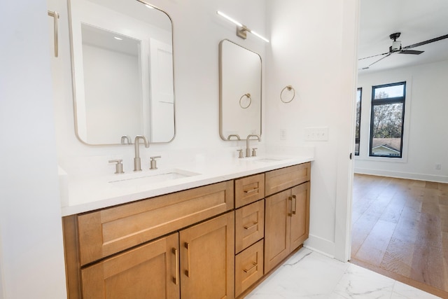 bathroom featuring hardwood / wood-style floors, ceiling fan, and vanity