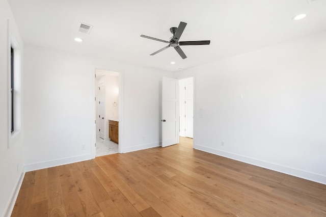 unfurnished bedroom with ensuite bath, ceiling fan, and light hardwood / wood-style floors