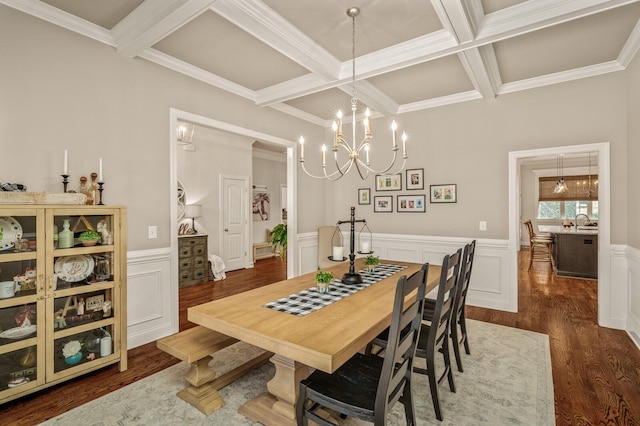 dining space with beamed ceiling, dark hardwood / wood-style flooring, crown molding, and coffered ceiling