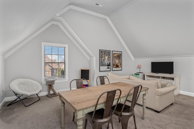 carpeted dining room featuring crown molding and lofted ceiling