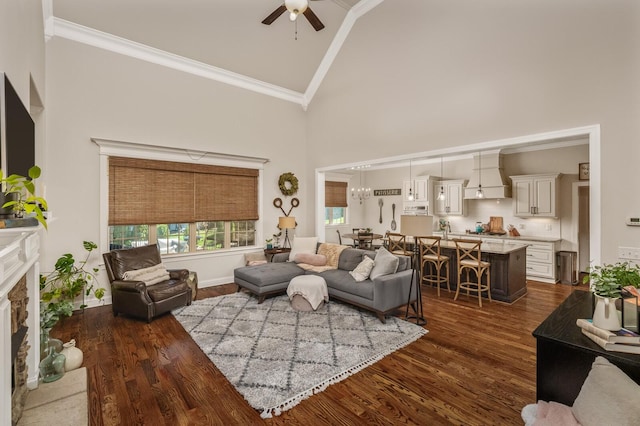 living room featuring high vaulted ceiling, a stone fireplace, crown molding, ceiling fan, and dark hardwood / wood-style flooring