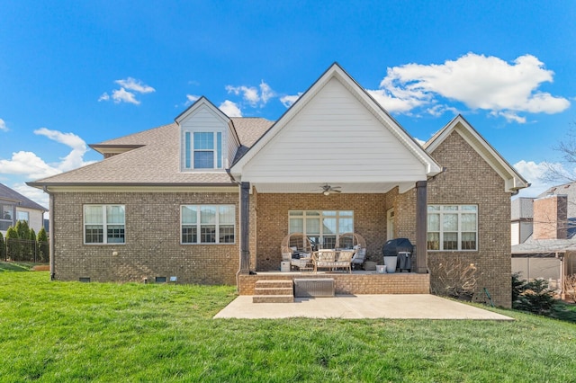 rear view of property featuring ceiling fan, a yard, and a patio