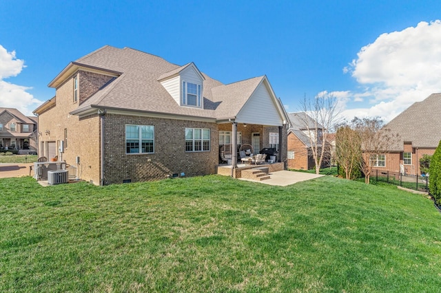 rear view of property with cooling unit, a patio area, and a yard