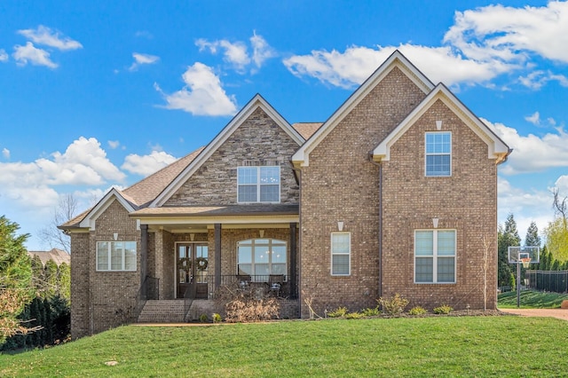 craftsman-style home with a front yard and covered porch