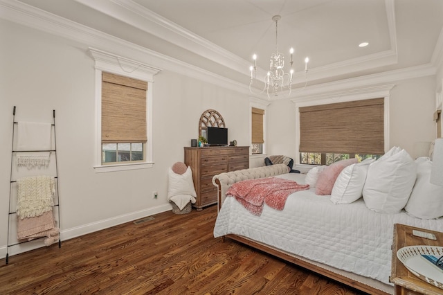 bedroom with a chandelier, dark hardwood / wood-style flooring, a tray ceiling, and crown molding