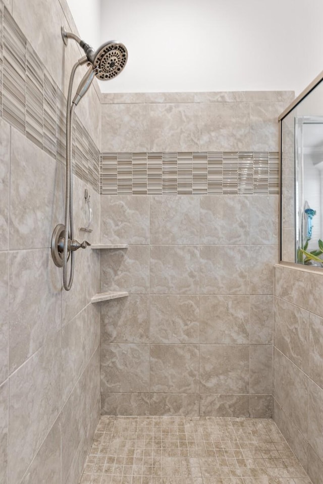 bathroom with tiled shower