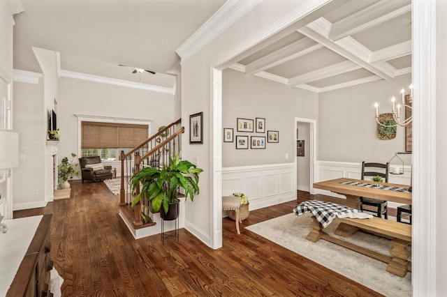 dining space featuring beam ceiling, dark hardwood / wood-style flooring, an inviting chandelier, and ornamental molding