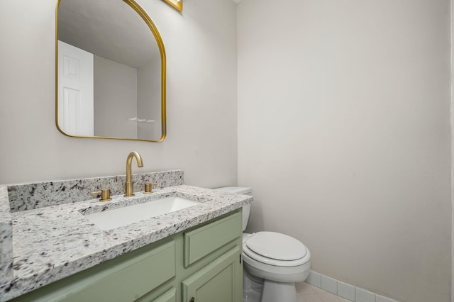 bathroom featuring tile patterned flooring, vanity, and toilet