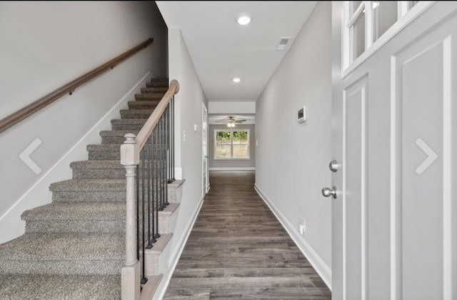 foyer featuring visible vents, a ceiling fan, dark wood finished floors, stairway, and baseboards