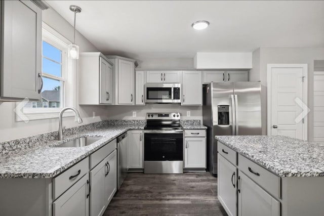 kitchen featuring gray cabinets, appliances with stainless steel finishes, and a sink