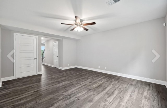 empty room featuring visible vents, baseboards, dark wood-type flooring, and a ceiling fan