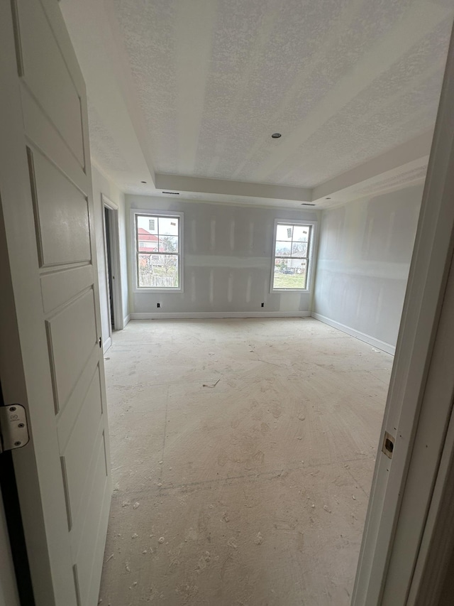 spare room featuring plenty of natural light and a textured ceiling