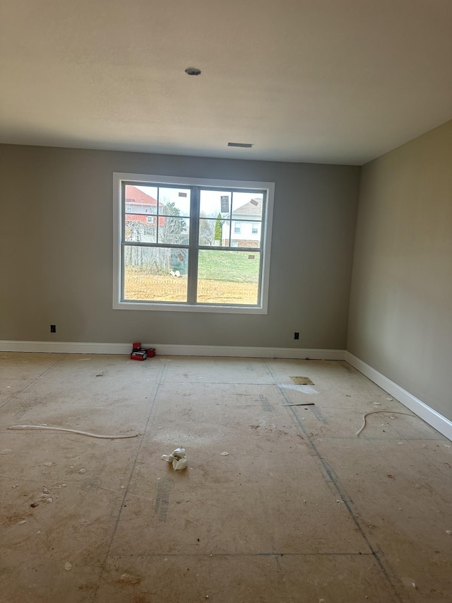 empty room featuring visible vents and baseboards