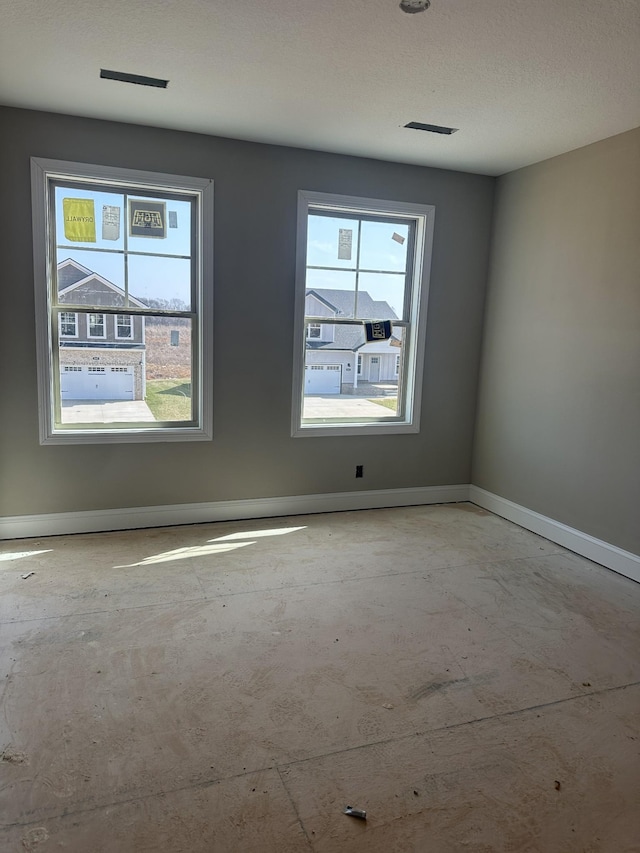 empty room with visible vents and baseboards