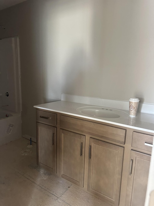 full bath with vanity and a bath