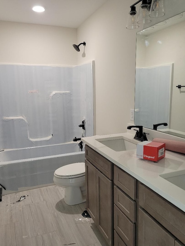 full bathroom featuring shower / bathing tub combination, vanity, and toilet