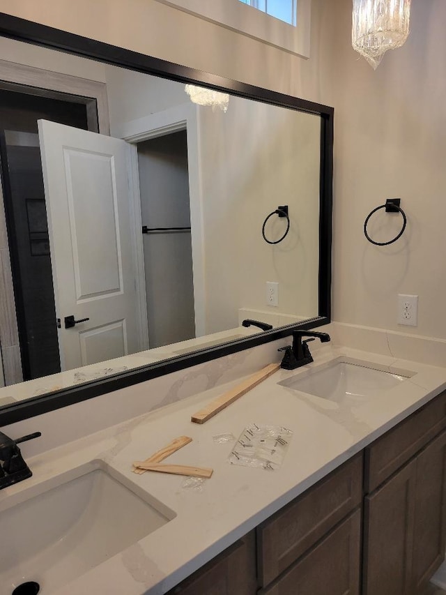 bathroom with vanity and a notable chandelier