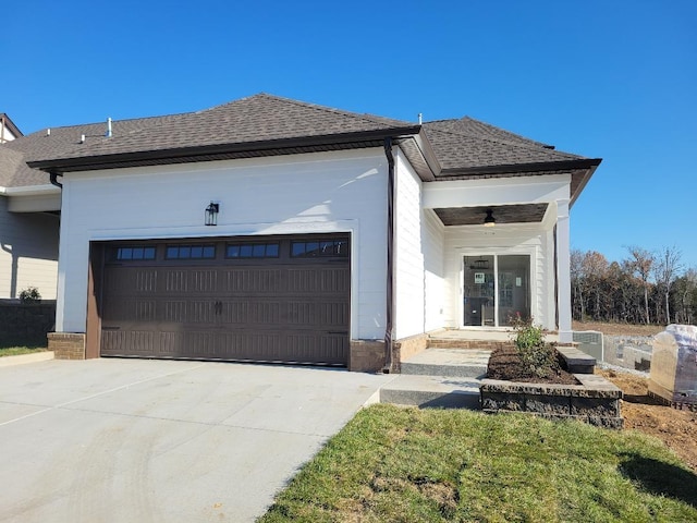 view of front of property with a garage and ceiling fan