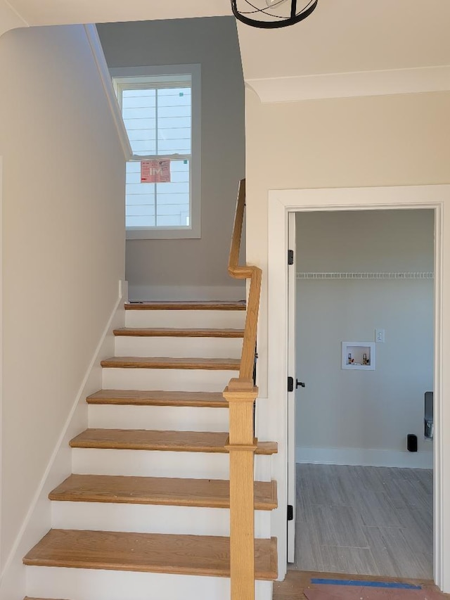 stairs featuring hardwood / wood-style flooring