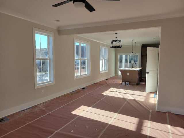 unfurnished room featuring ceiling fan and crown molding