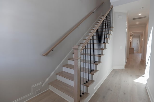 staircase with recessed lighting, wood finished floors, visible vents, and baseboards