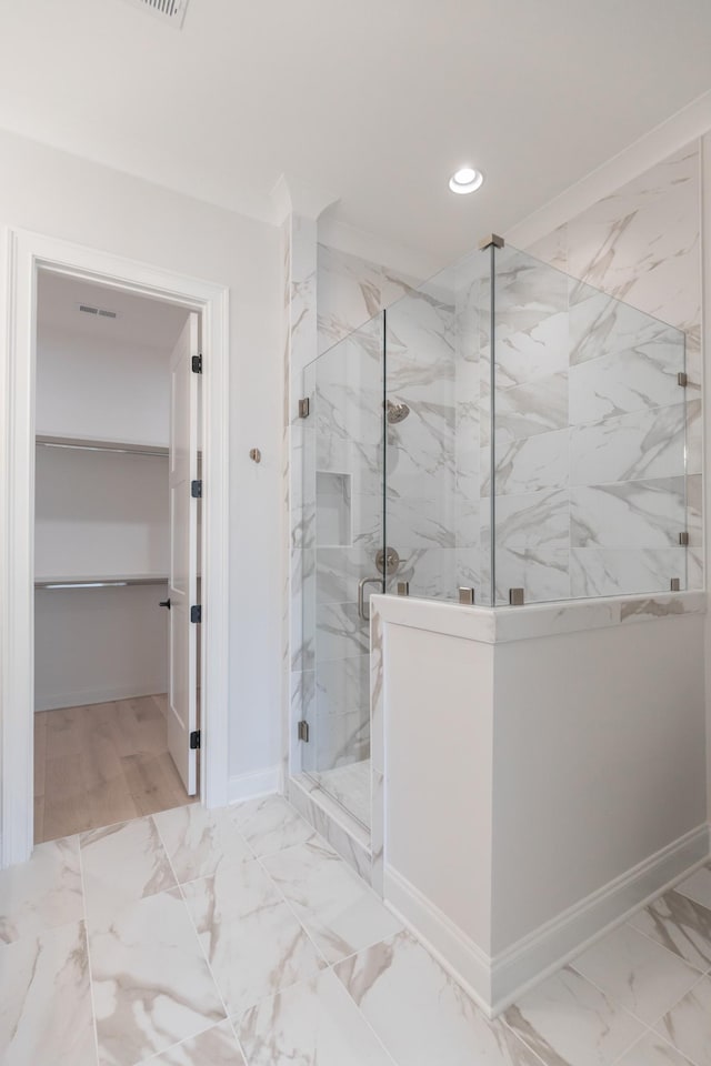 full bathroom featuring recessed lighting, marble finish floor, a marble finish shower, and baseboards