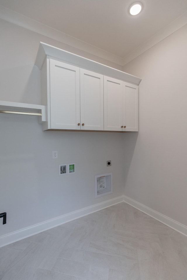 clothes washing area featuring hookup for a washing machine, baseboards, cabinet space, electric dryer hookup, and crown molding